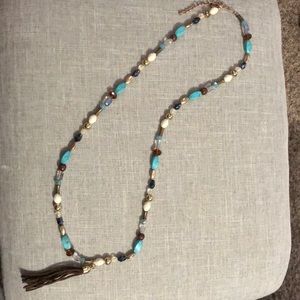 Long beaded necklace with tassel.